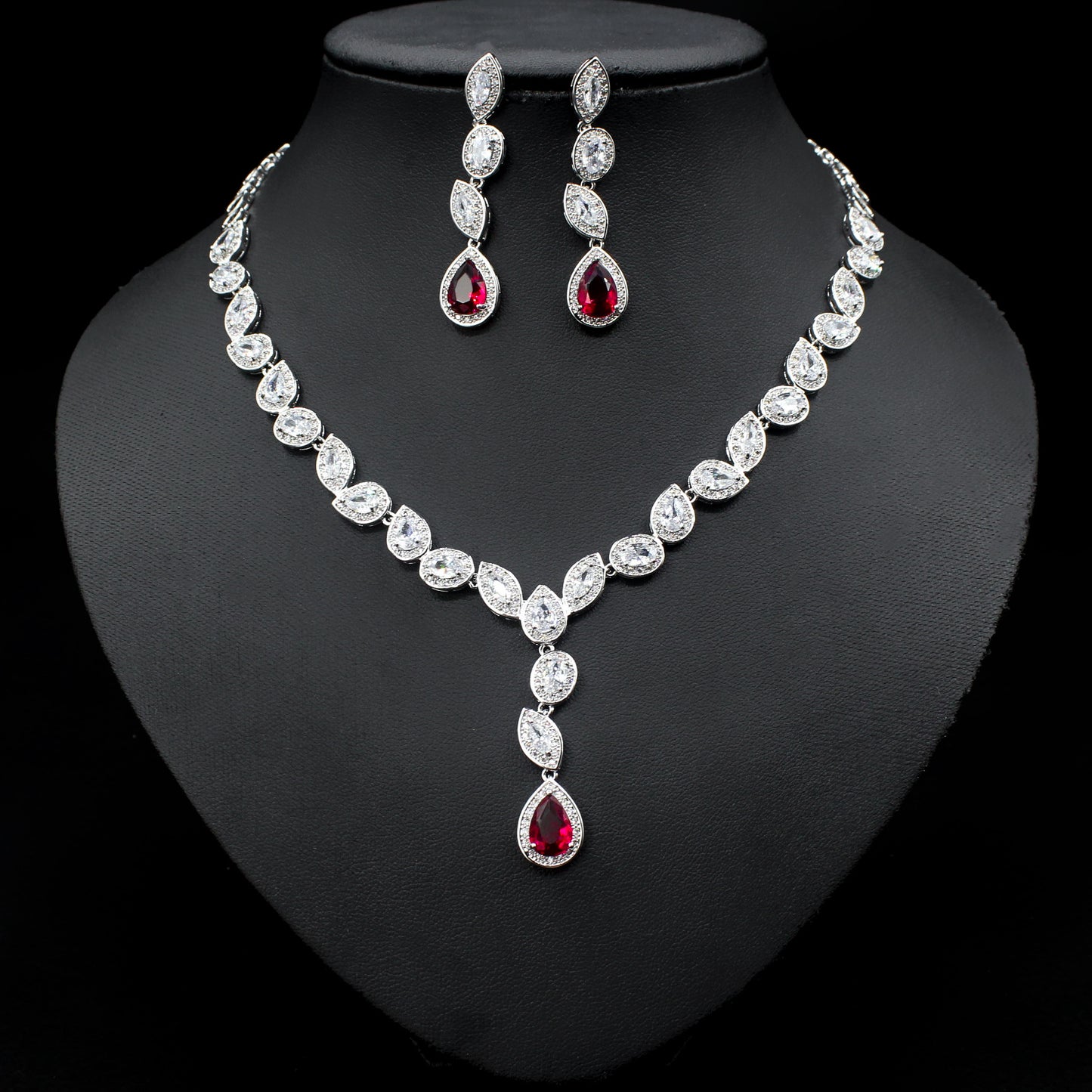 a necklace and earrings set on a mannequin