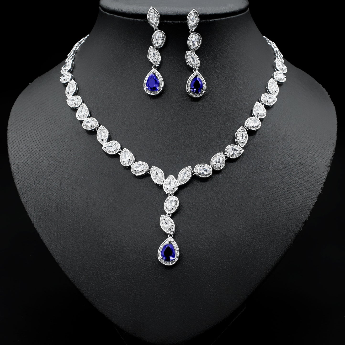 a necklace and earring set on a mannequin
