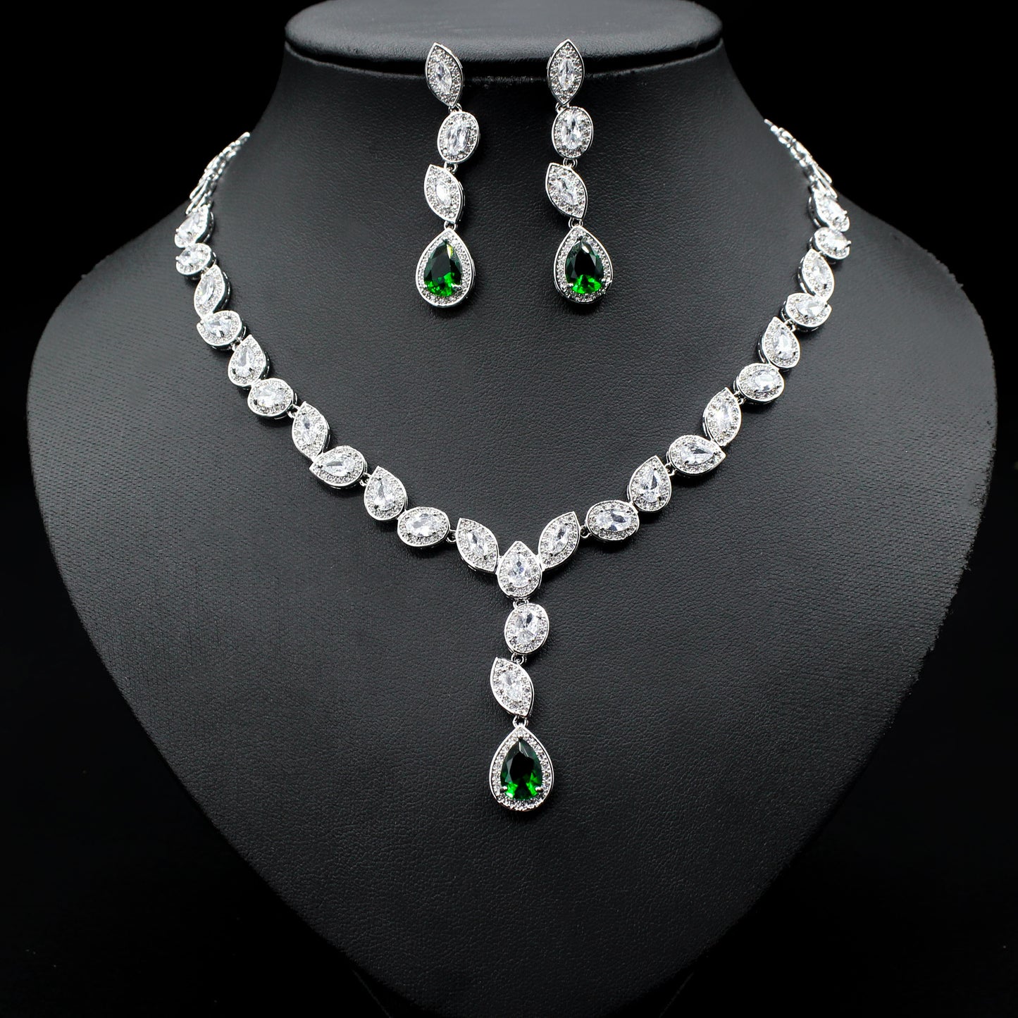 a necklace and earring set on a mannequin