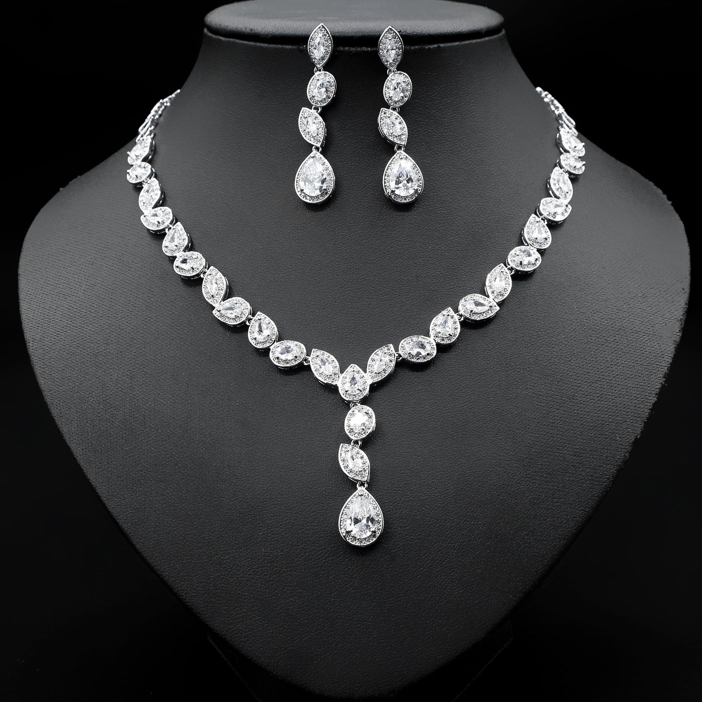 a necklace and earrings set on a mannequin
