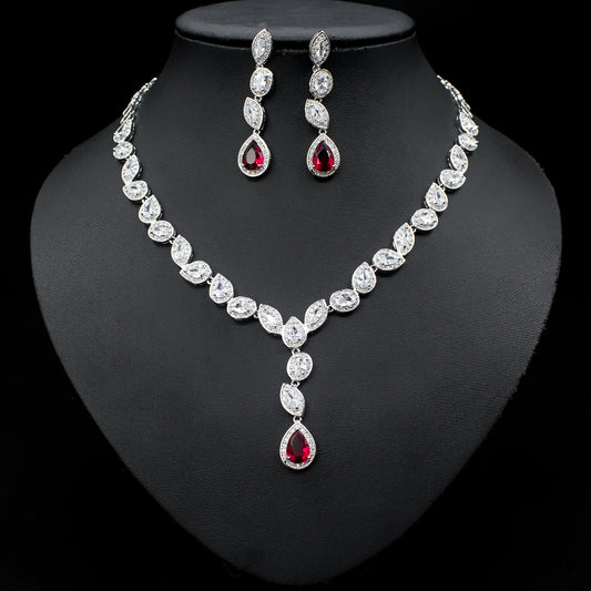 a necklace and earrings set on a mannequin