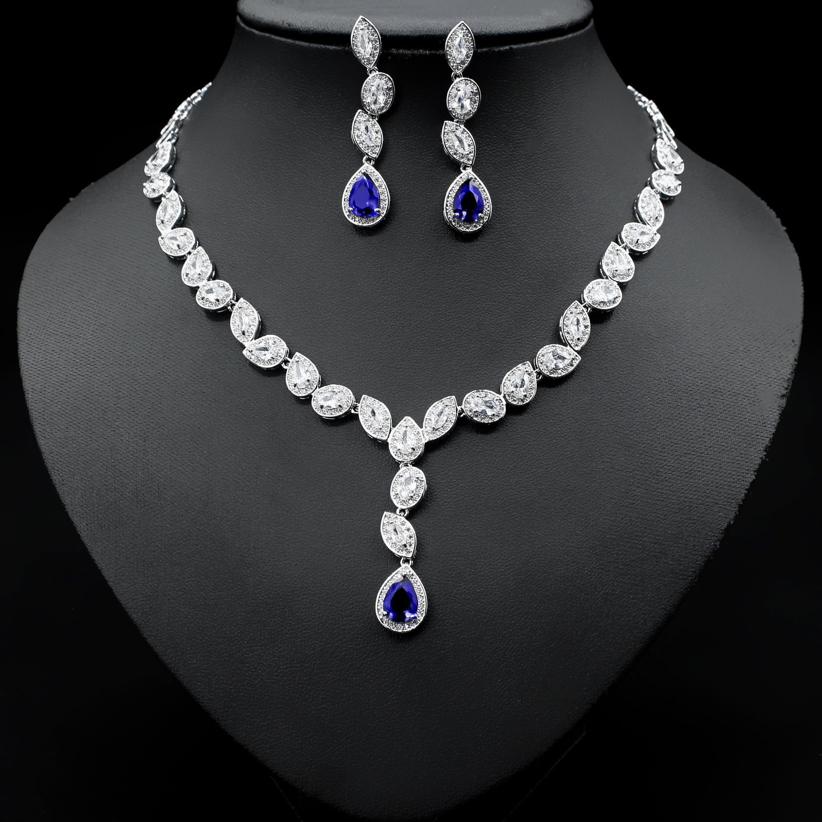 a necklace and earring set on a mannequin
