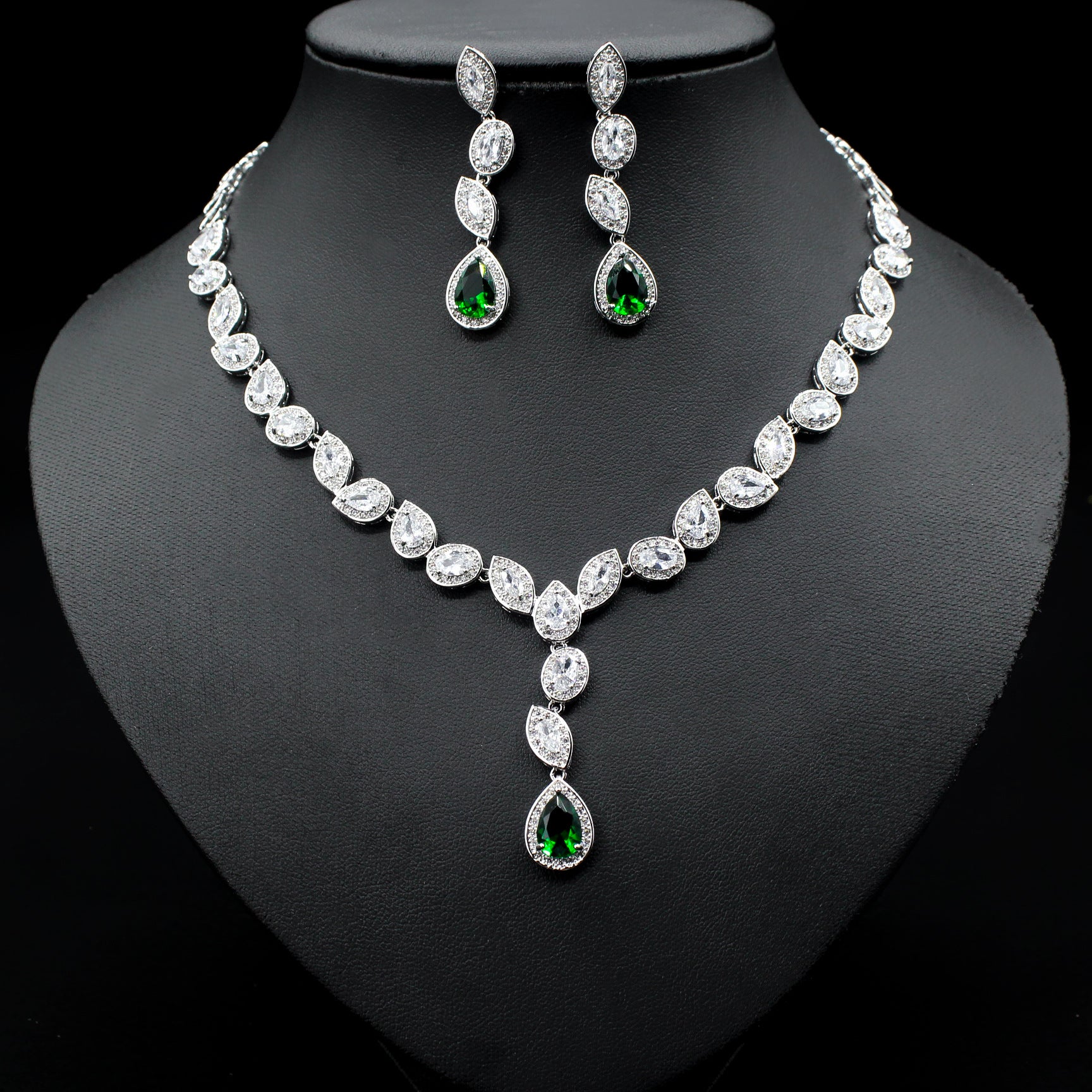 a necklace and earring set on a mannequin